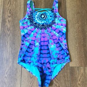 A justice tie dye swimsuit with a crossed back